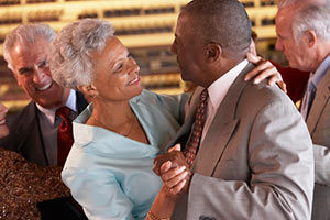 Senior couple dancing and thinking about long term care insurance options.